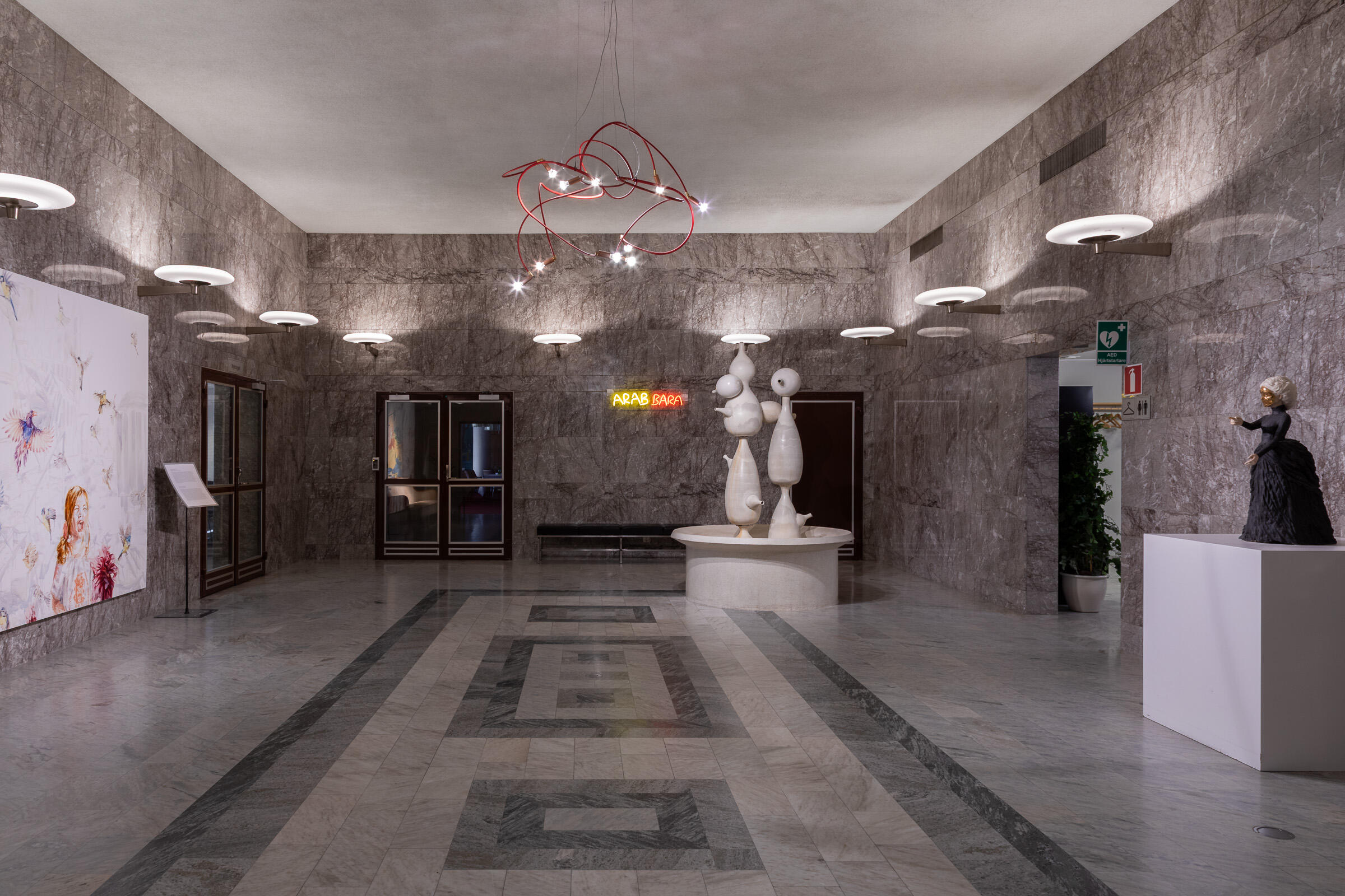 Interior architectural photography of the historic Fontänhallen at Folksam headquarters, Bohusgatan 14, Stockholm. Featuring mar Interior photography of Fontänhallen at Folksam headquarters in Stockholm, featuring marble walls, geometric stone flooring and Brunnen, a ceramic fountain sculpture by Swedish designer Stig Lindberg.
